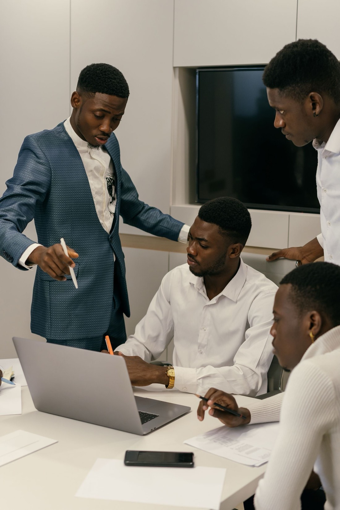 African professionals collaborating around a laptop in a training session